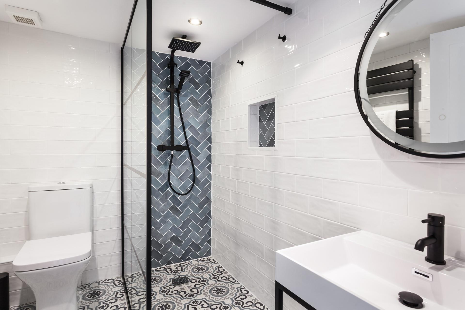 The family bathroom is decorated to a high standard with contemporary tiling and a rainfall shower.