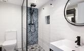 The family bathroom is decorated to a high standard with contemporary tiling and a rainfall shower. - Thumbnail Image