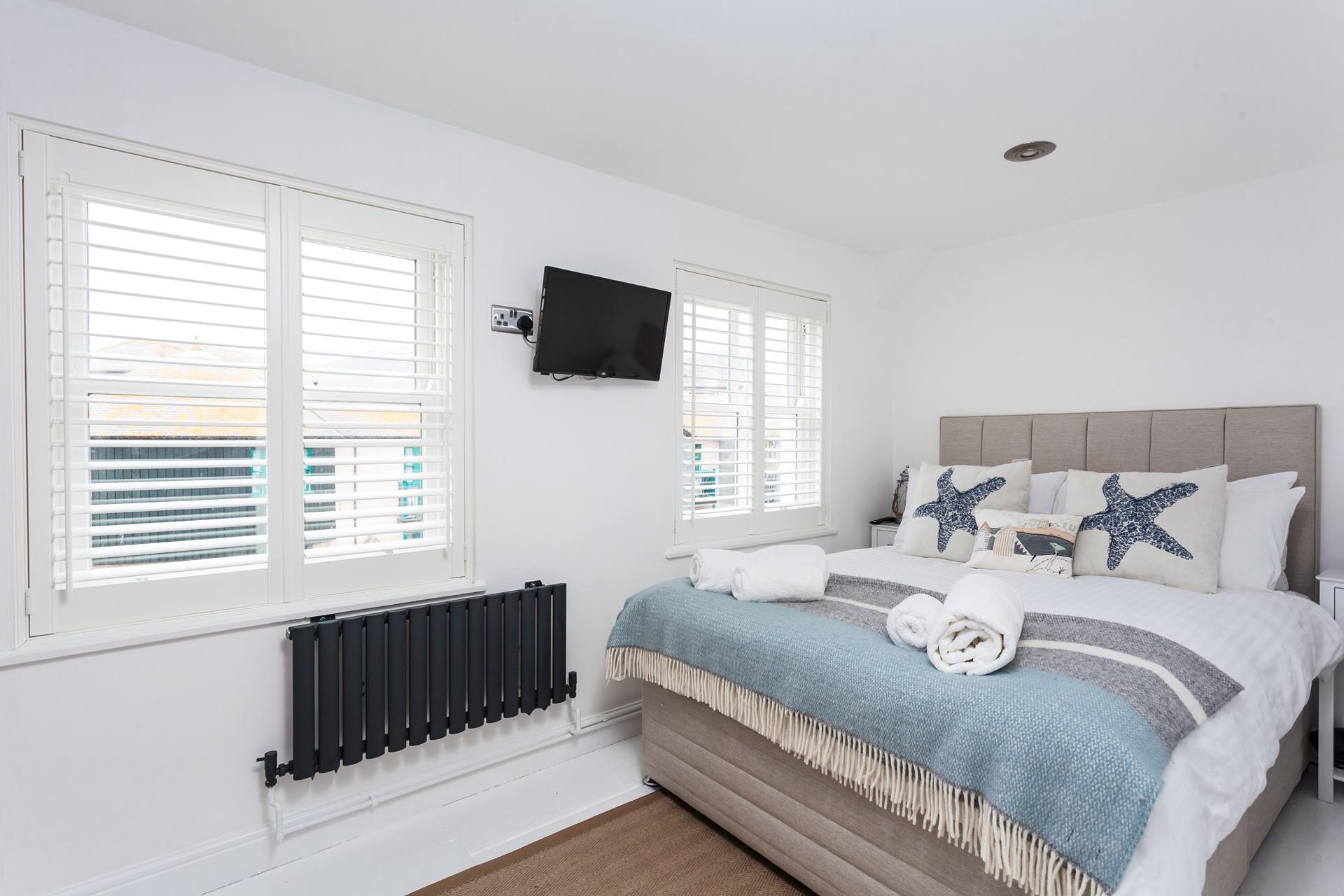 Bedroom 1 has a double textile divan bed and is decorated with a lovely blue seaside theme.