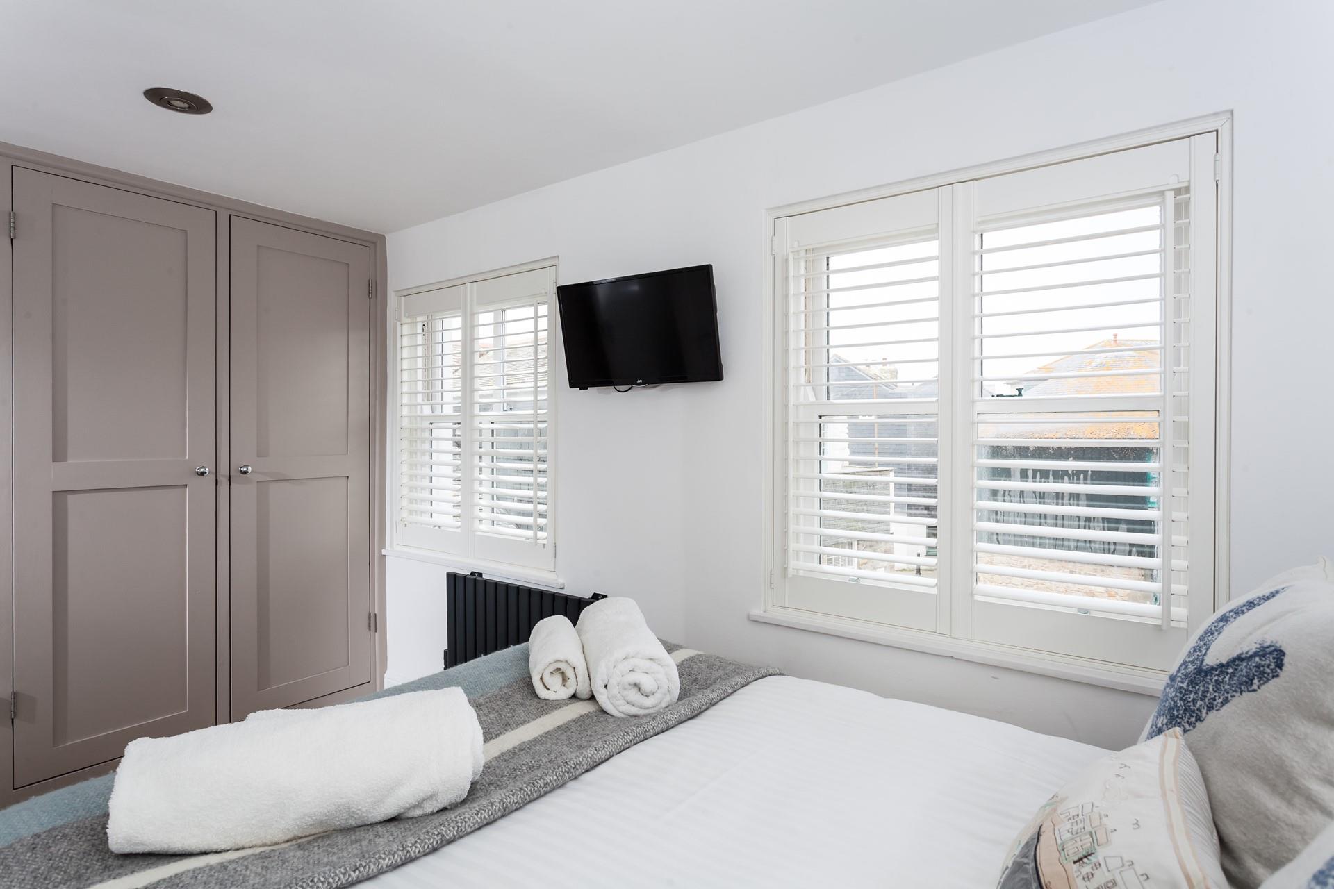 Bedroom 1 has painted wood built-in wardrobes with plenty of space for all your holiday clothes.