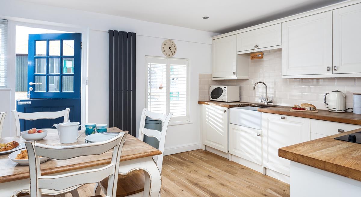 Enjoy breakfast on the farmhouse-style dining table and chairs before heading out for the day.