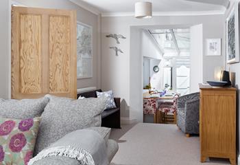 The open plan living area with steps down to the dining area and kitchen.