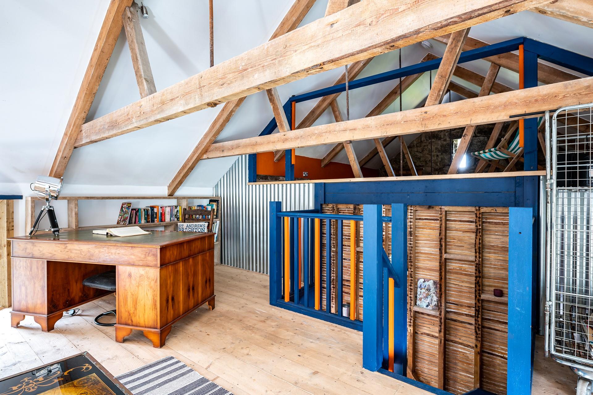 There is a mezzanine level with seating and a desk.