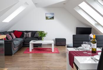 Sink into the sumptuous L-shaped sofa in the stylish, light-filled sitting room.