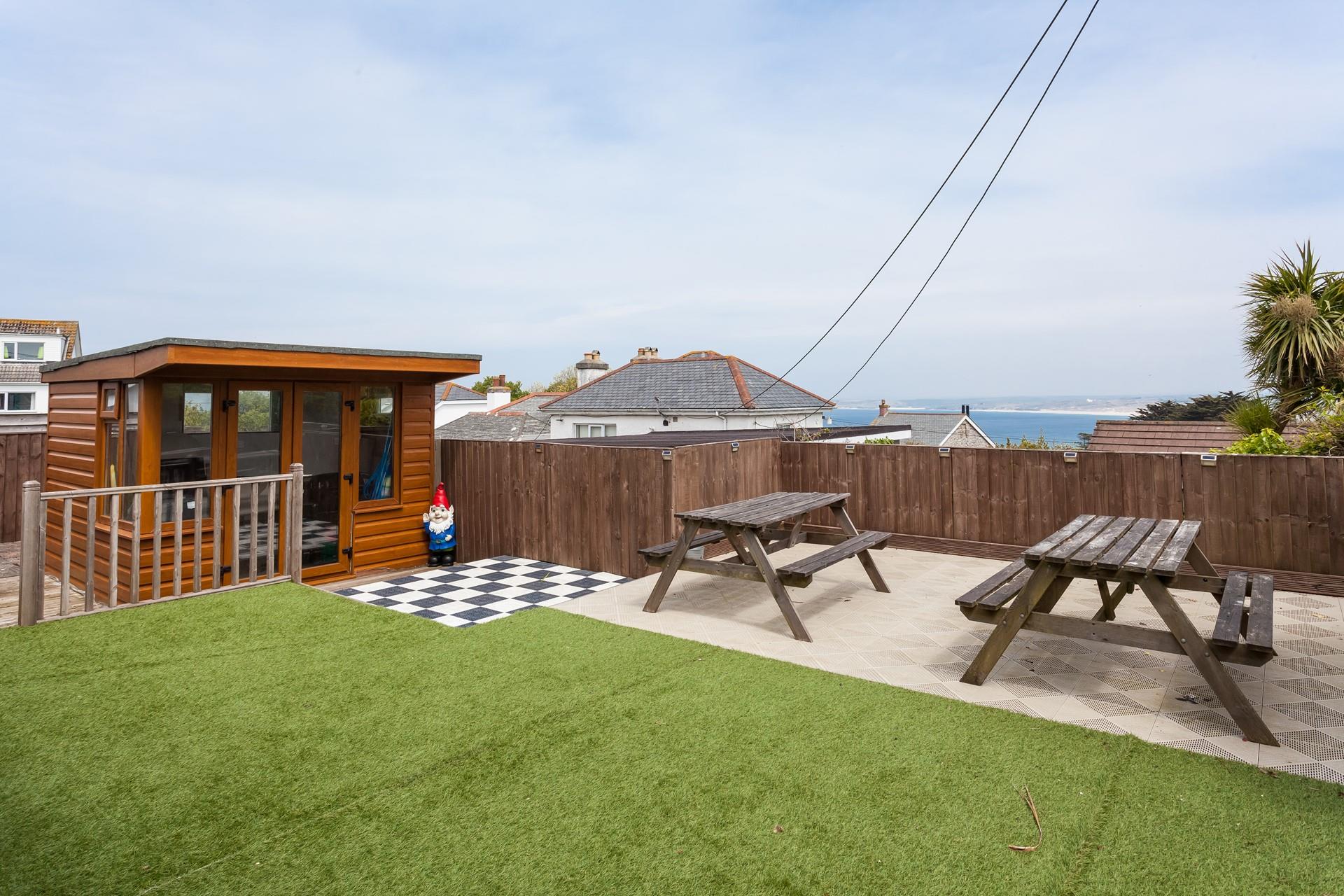 Thoughtfully designed, the wonderfully private garden is the perfect sun trap benefitting from distant sea views. 