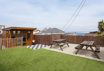 Thoughtfully designed, the wonderfully private garden is the perfect sun trap benefitting from distant sea views. 