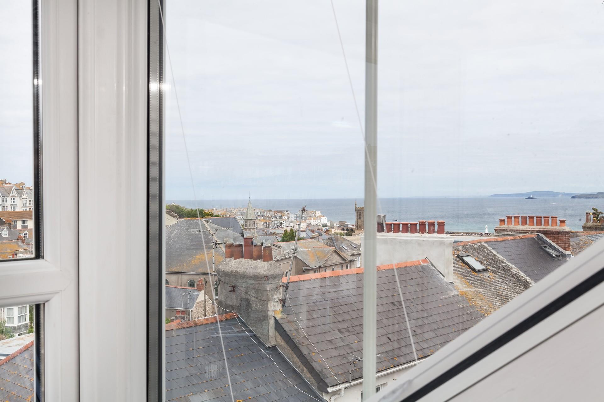 Look across the rooftops and out to sea.