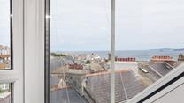 Look across the rooftops and out to sea.