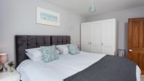 Sink into the super-king bed in this classy bedroom.