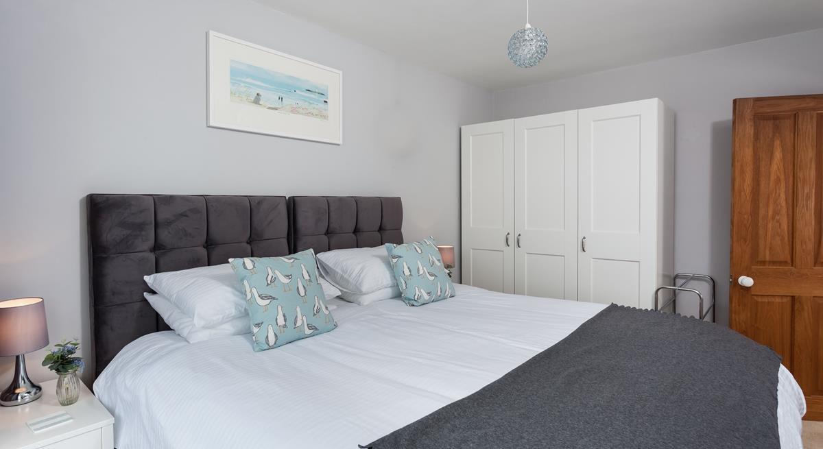 Sink into the super-king bed in this classy bedroom.