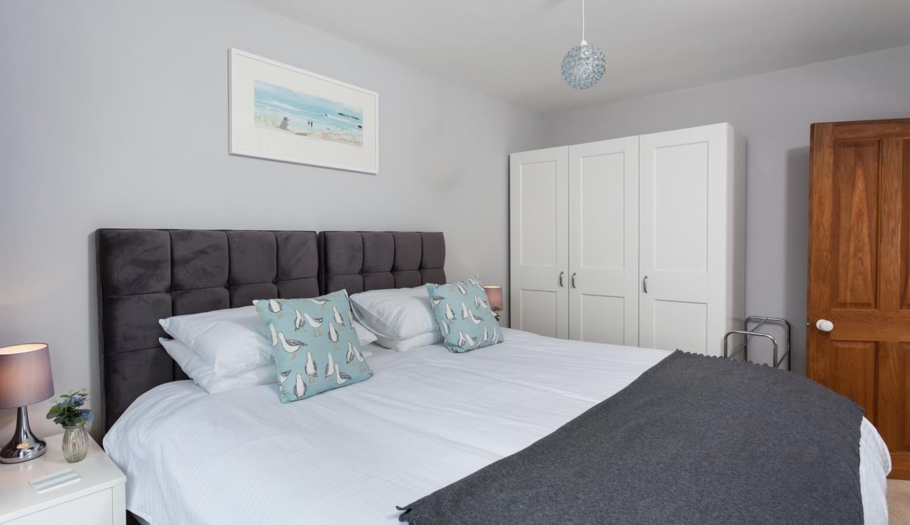 Sink into the super-king bed in this classy bedroom.