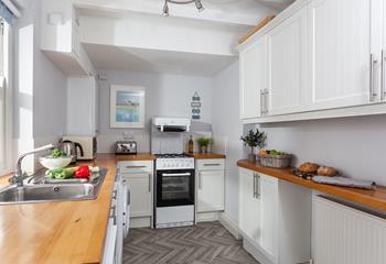 Prepare dinner for the family or friends in this well-equipped kitchen.