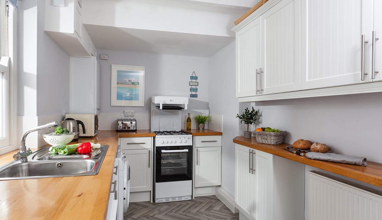 Prepare dinner for the family or friends in this well-equipped kitchen.