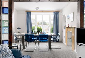 Draw back the curtains and let the light flood into this contemporary dining room through the bay window.