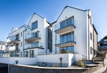 Glass balconies allow natural light to flood in.