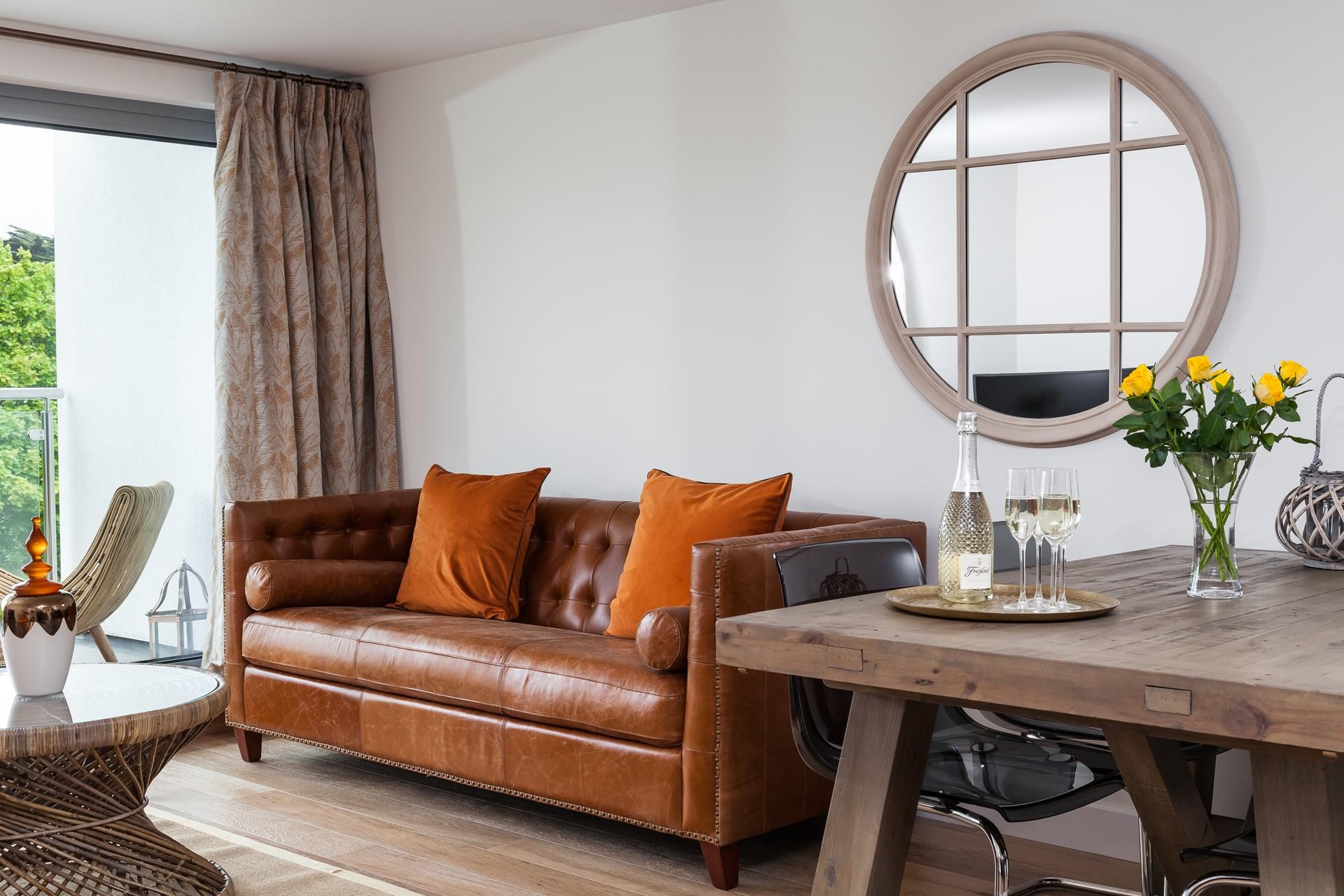 Relax in the leather Chesterfield sofa with a glass of your favourite tipple, while the sea breeze floats in through the open patio doors. 