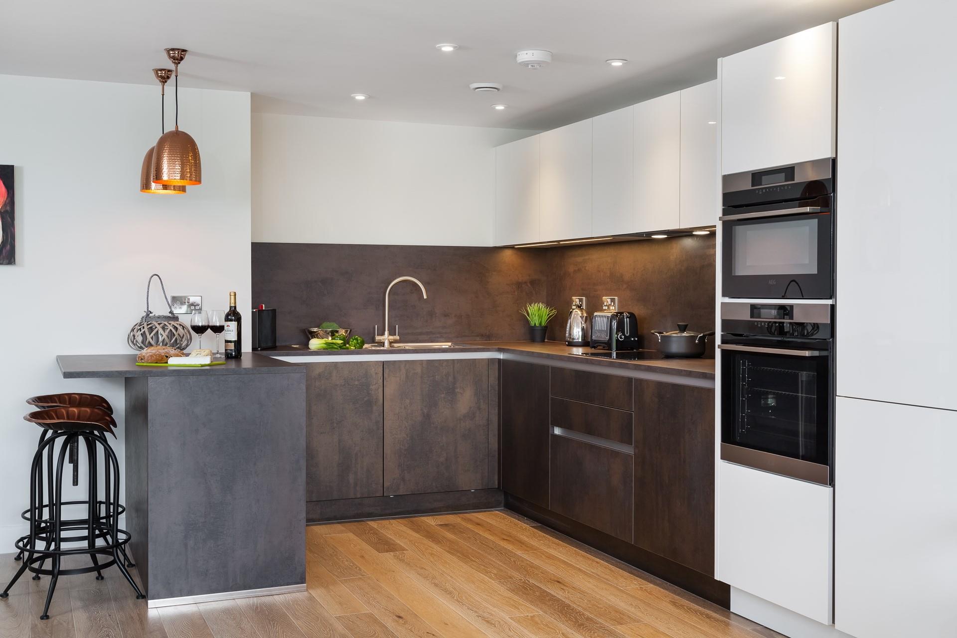 The kitchen is spacious, highly functional and features a selection of mod-cons. We love the copper lights and bar stools. 