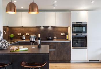 Sleek and stylish, the contemporary open plan kitchen incorporates a breakfast bar, perfect for socialising with whoever is cooking up a feast!