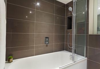 Sleek glossy tiles and a power shower create a spa-like experience for your daily showers. 