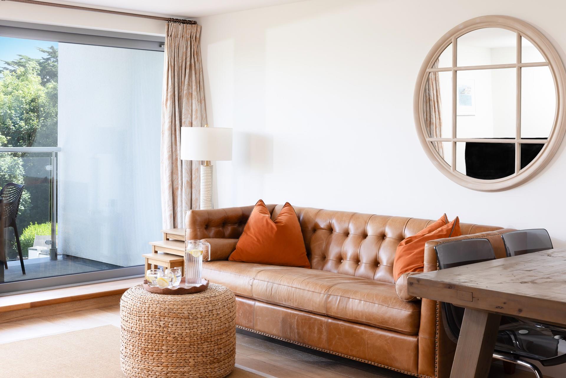 Relax in the leather Chesterfield sofa with a glass of your favourite tipple, while the sea breeze floats in through the open patio doors. 
