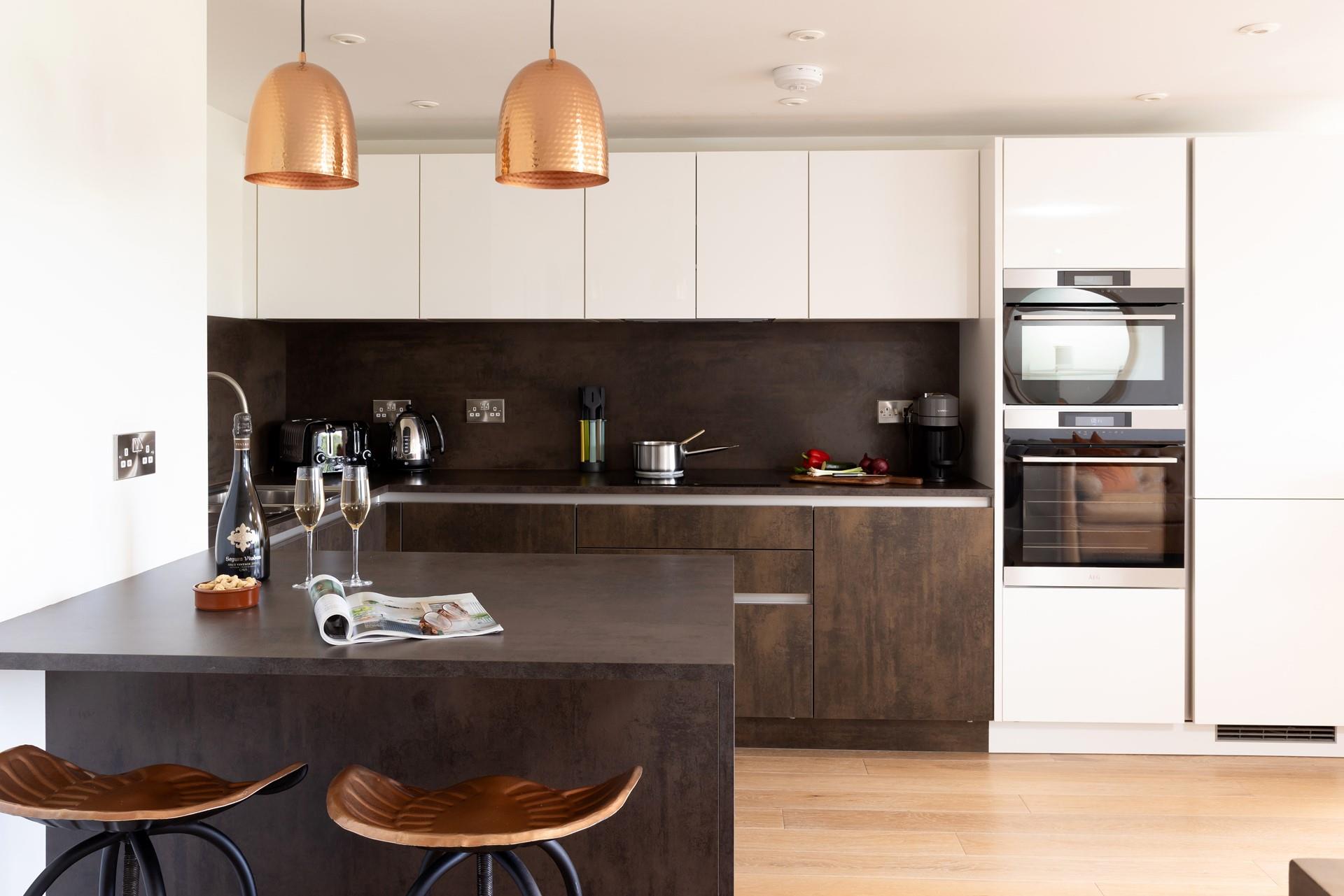 The kitchen is spacious, highly functional, and features a selection of mod-cons. 