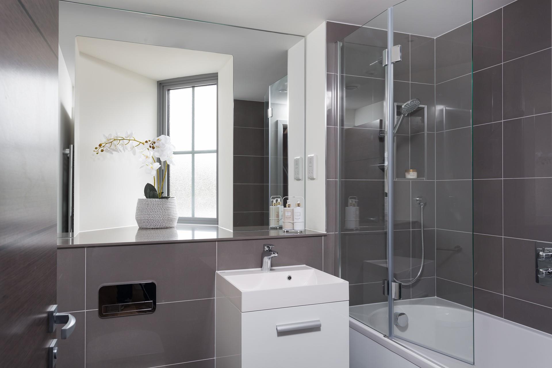 The modern bathroom has a stylish minimalistic finish; end the day with a relaxing soak in the bath. 