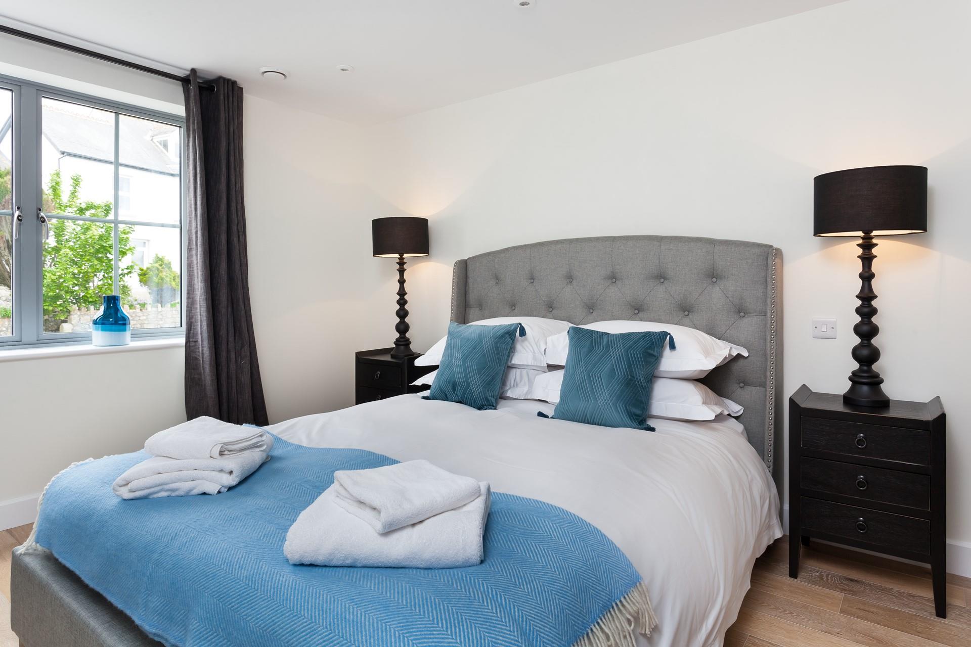 Bedroom 1 has a luxurious king size bed with elegant furnishings; settle in for a blissful night's sleep. 