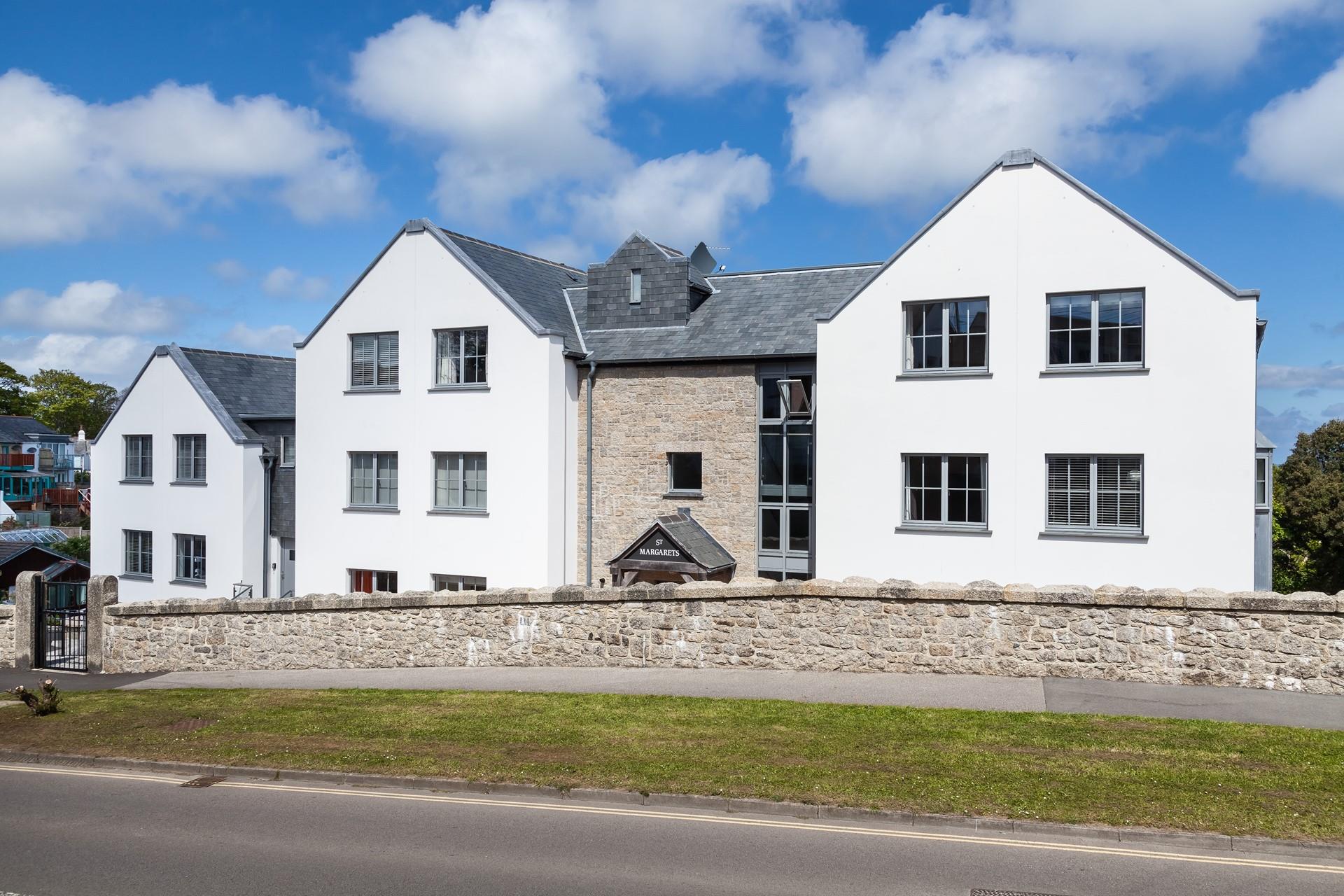 Traditional stone, slate roofing and great architectural design have achieved a building with great presence.