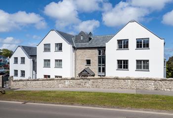 Traditional stone, slate roofing and great architectural design have achieved a building with great presence.