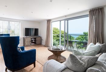 Pour a glass of bubbles, relax into one of the luxurious chairs and soak up the views through the balcony doors. 