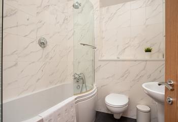 The bathroom is beautifully designed and even has a bath to enjoy a bubbly soak after a day on the beach!