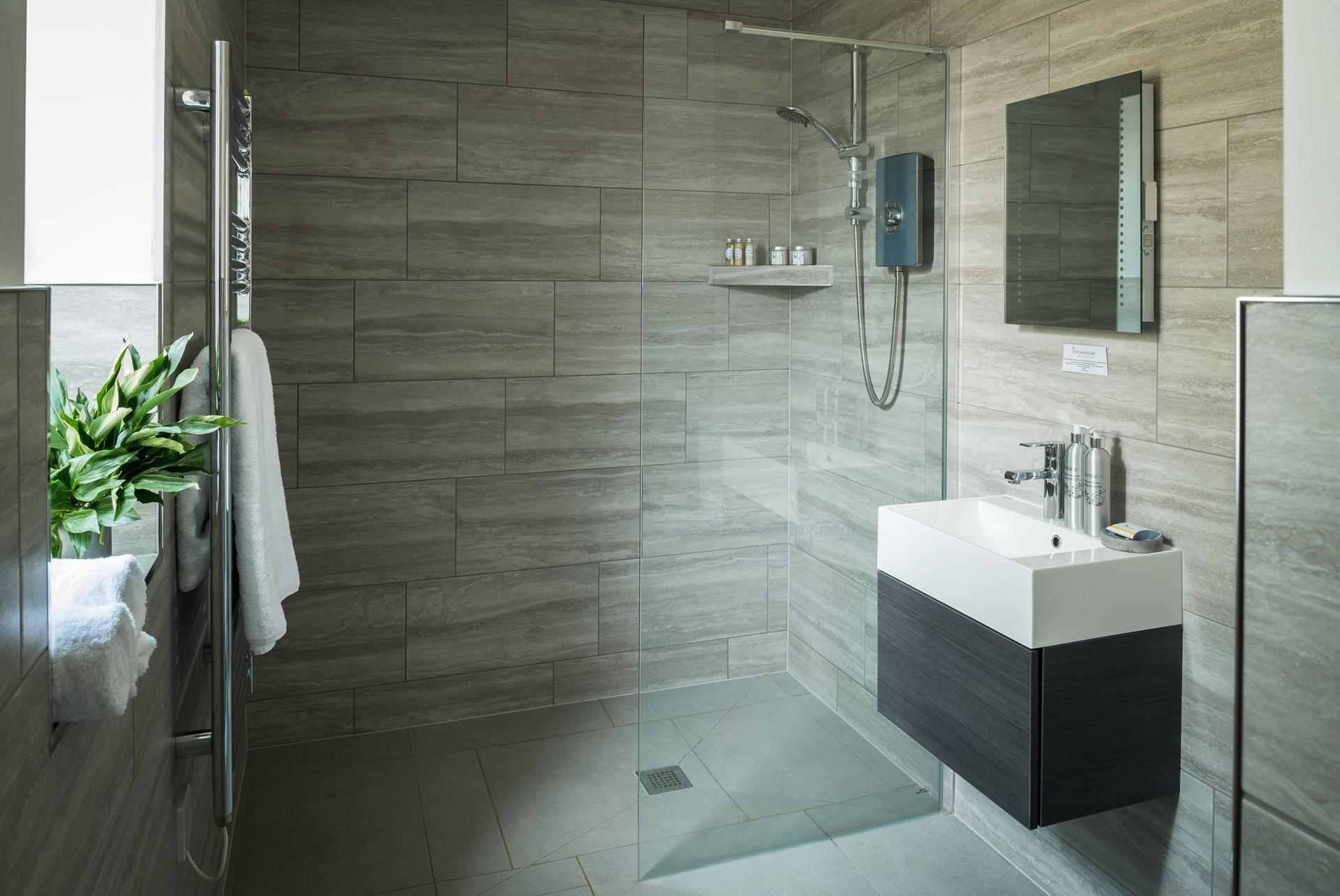 Bedroom 1 has a modern en suite with a large walk-in shower. 