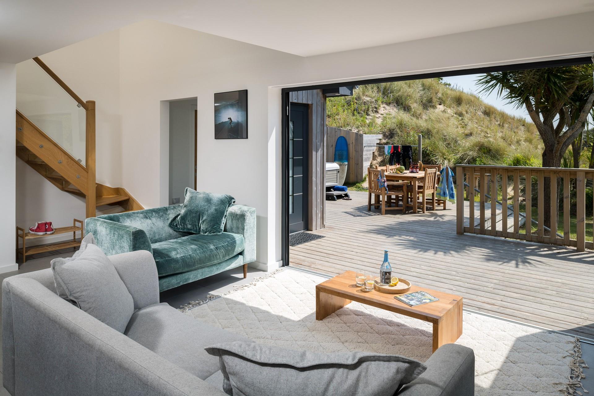 Bi-fold doors open up from the open plan living area onto the property's private decking area letting the Cornish sun pour in. 