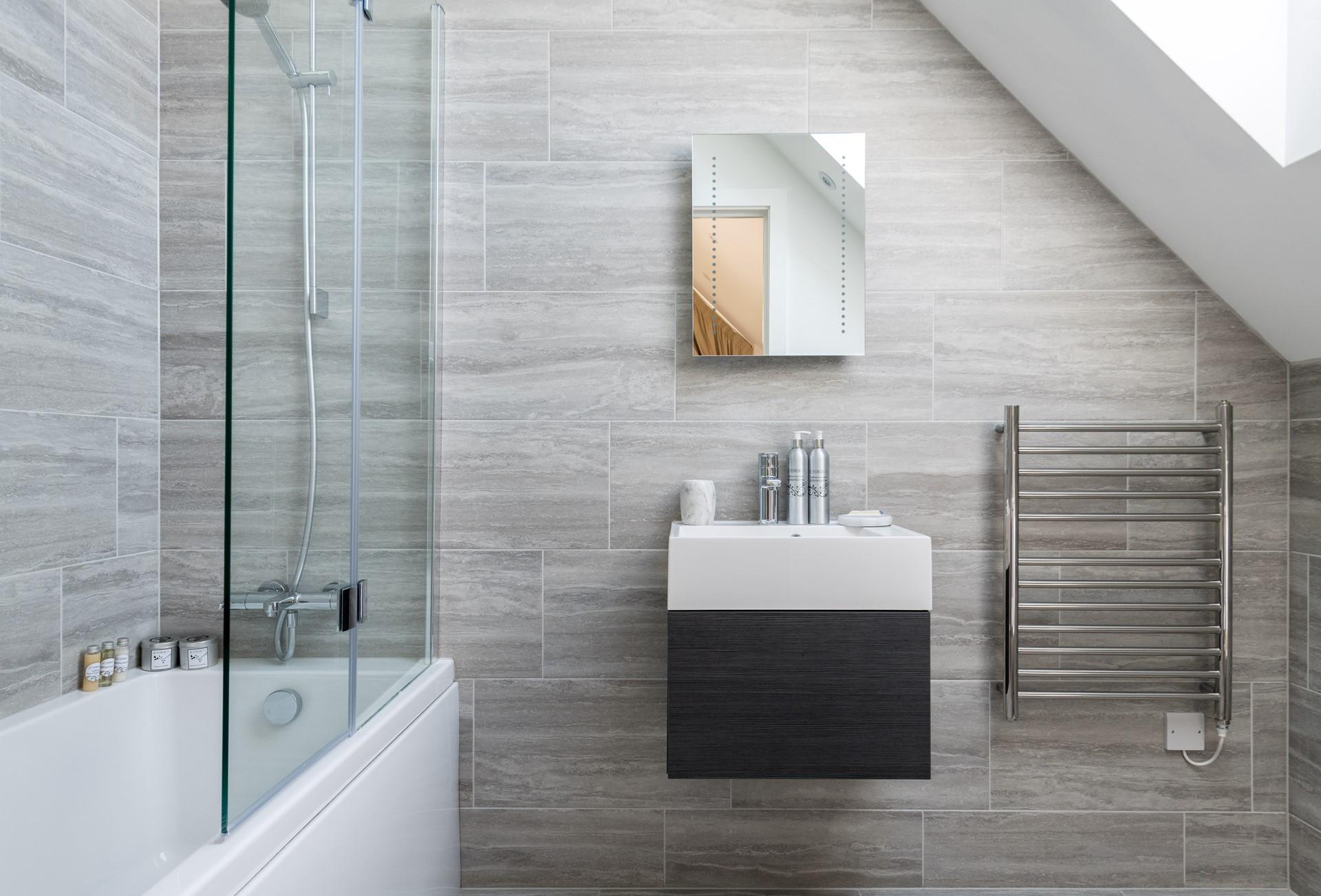 Bedroom 2 has an en suite with a bath and overhead shower for pure indulgence.