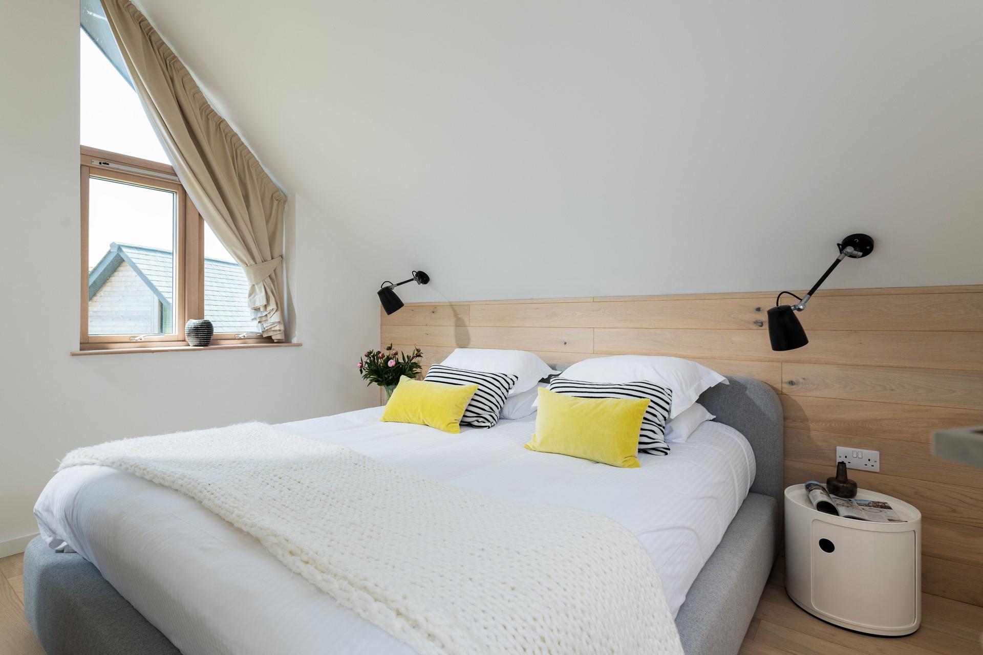 Bedroom 3 has a comfy super king size bed complete with wooden cladding.