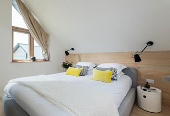 Bedroom 3 has a comfy super king size bed complete with wooden cladding.
