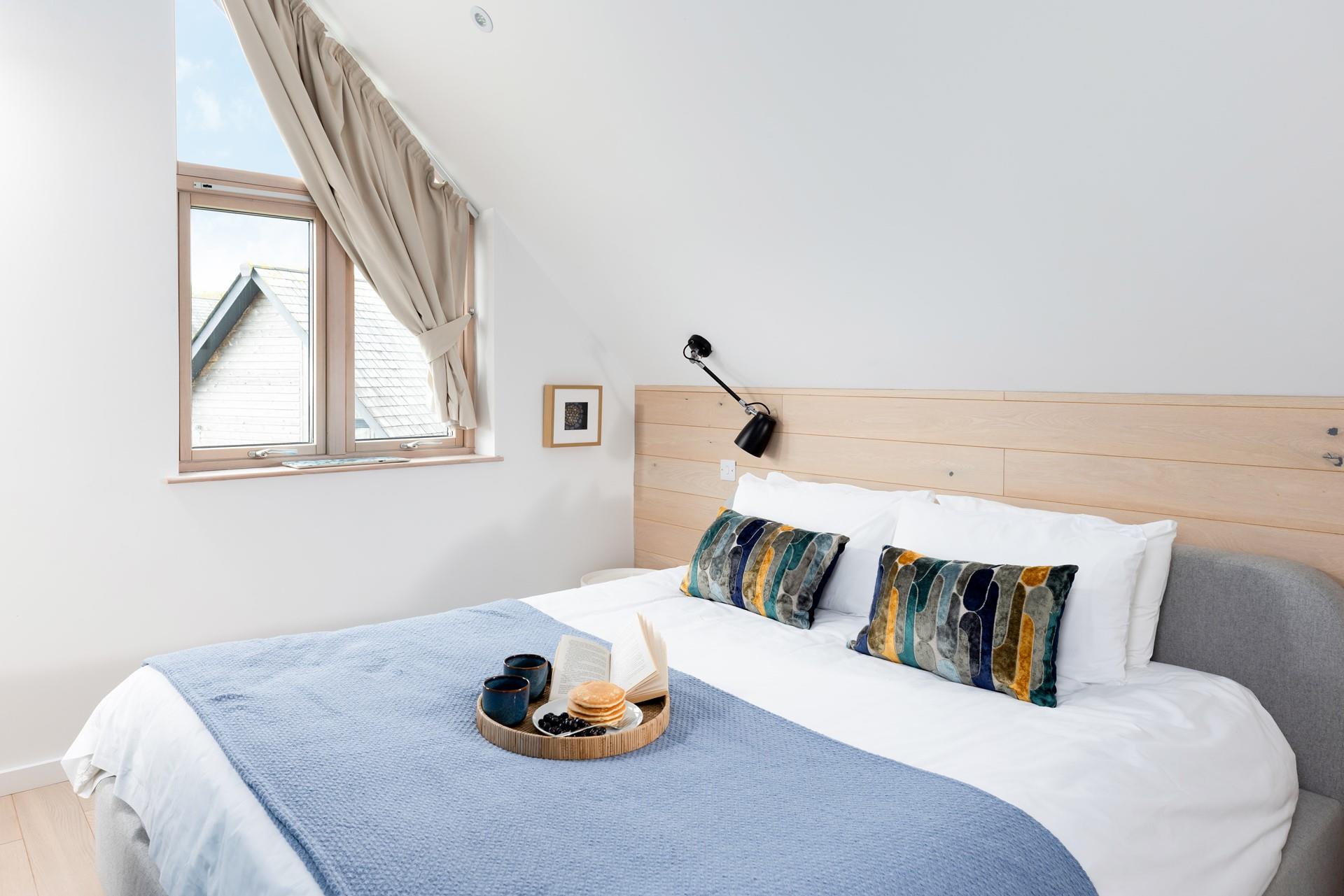 Bedroom 3 has a comfy super king size bed complete with wooden cladding.