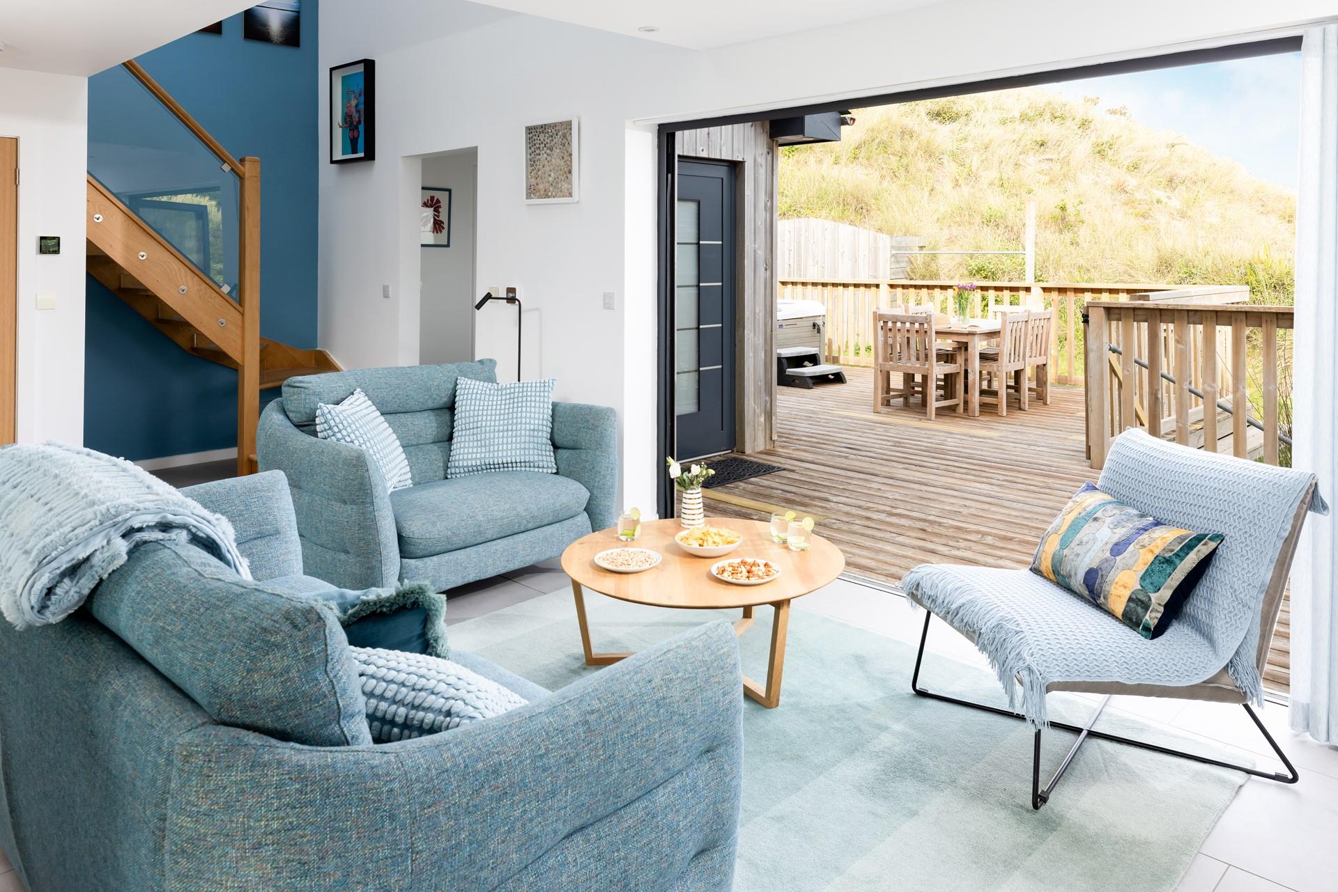 Bi-fold doors open up from the open plan living area onto the property's private decking area letting the Cornish sun pour in. 