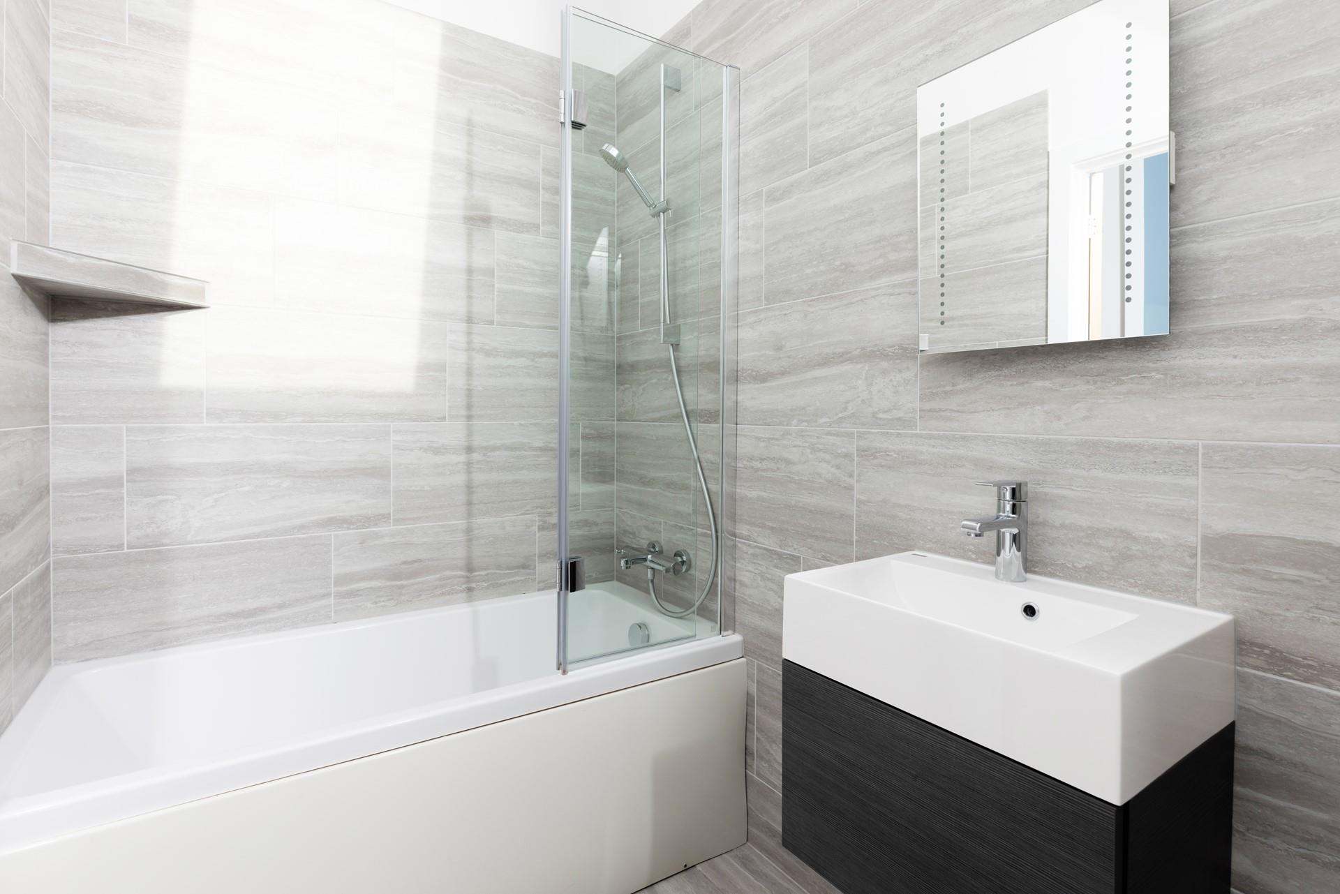 Bedroom 2 has an en suite with a bath and overhead shower for pure indulgence.
