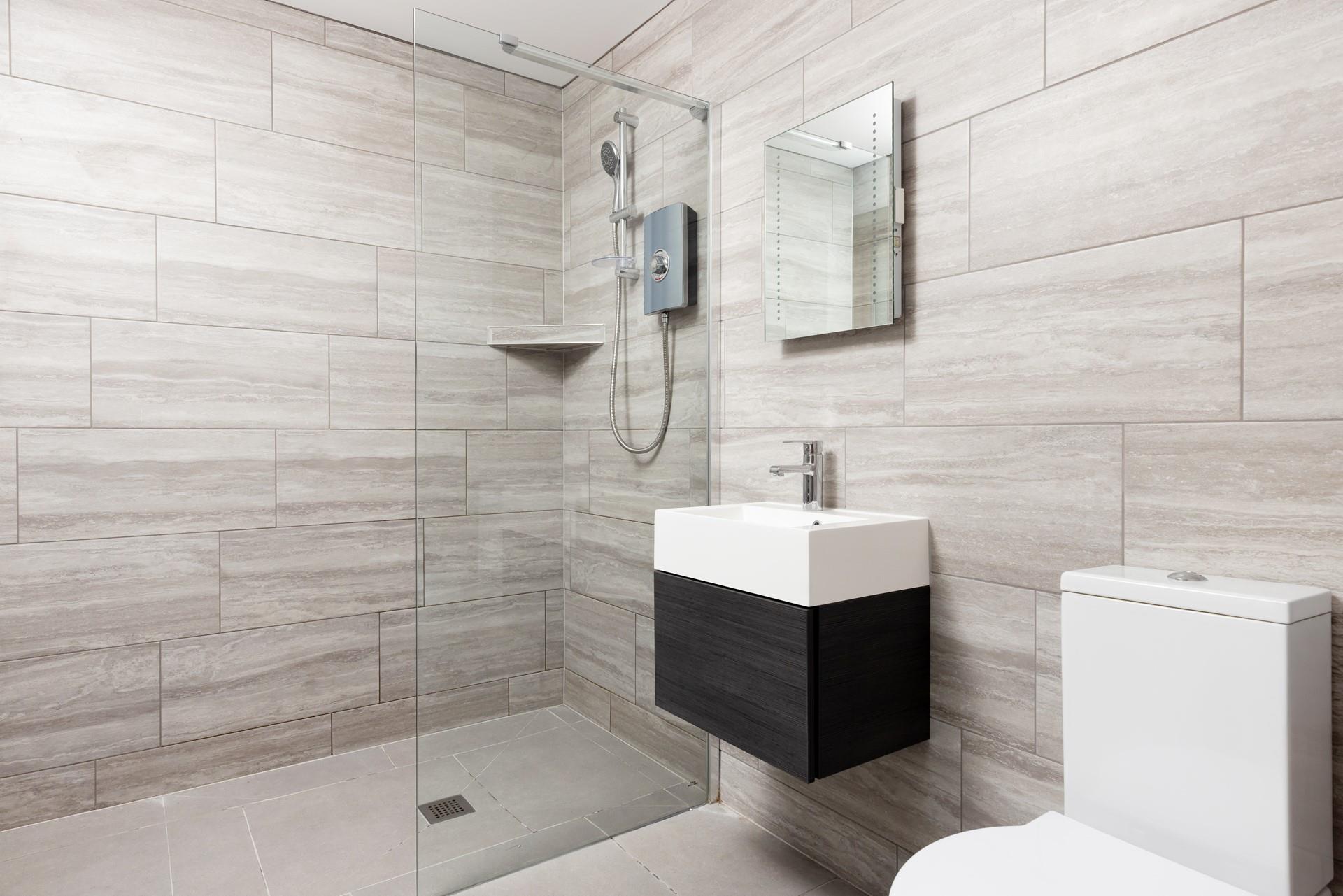 Bedroom 1 has a modern en suite with a large walk-in shower. 