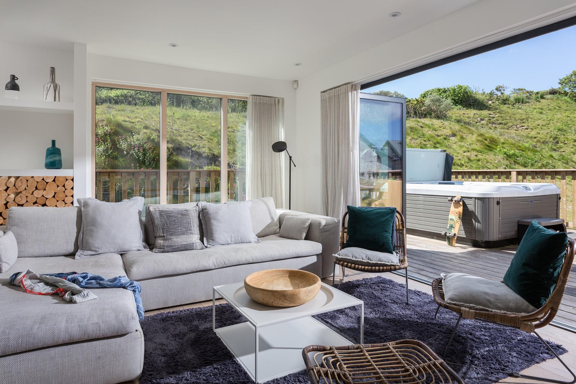 Beautiful grey and blue shades in the comfy sitting room reflect the seaside location.