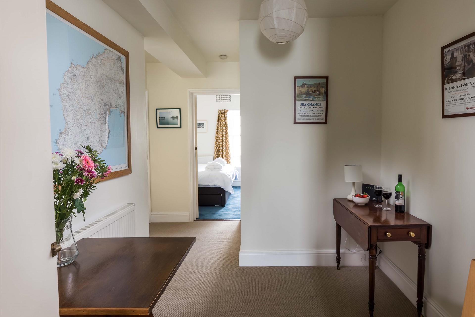 The entrance hall gives access to the bedroom and living areas.
