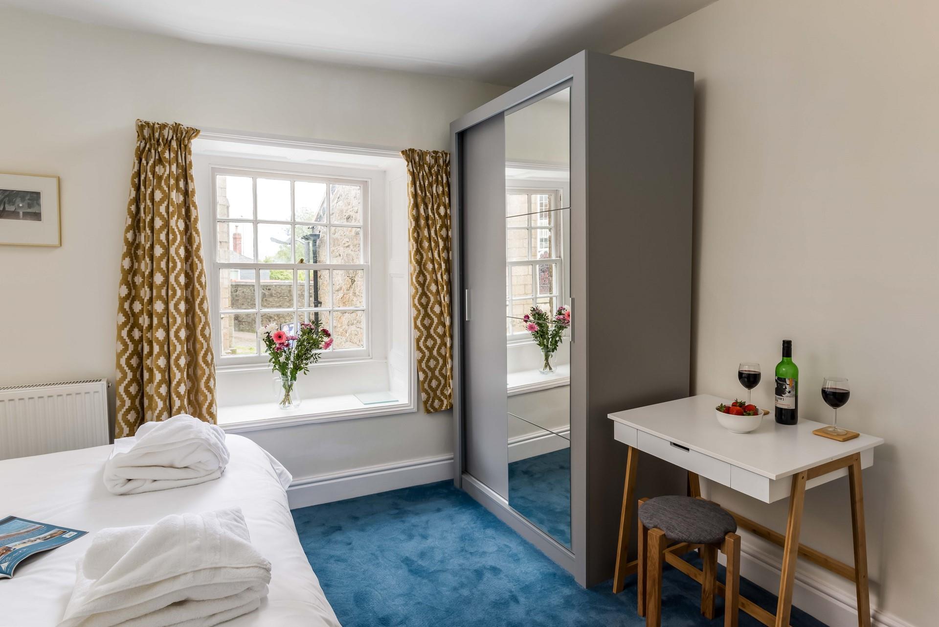 The bedroom with a modern en suite shower is the perfect base to rest your head at night.