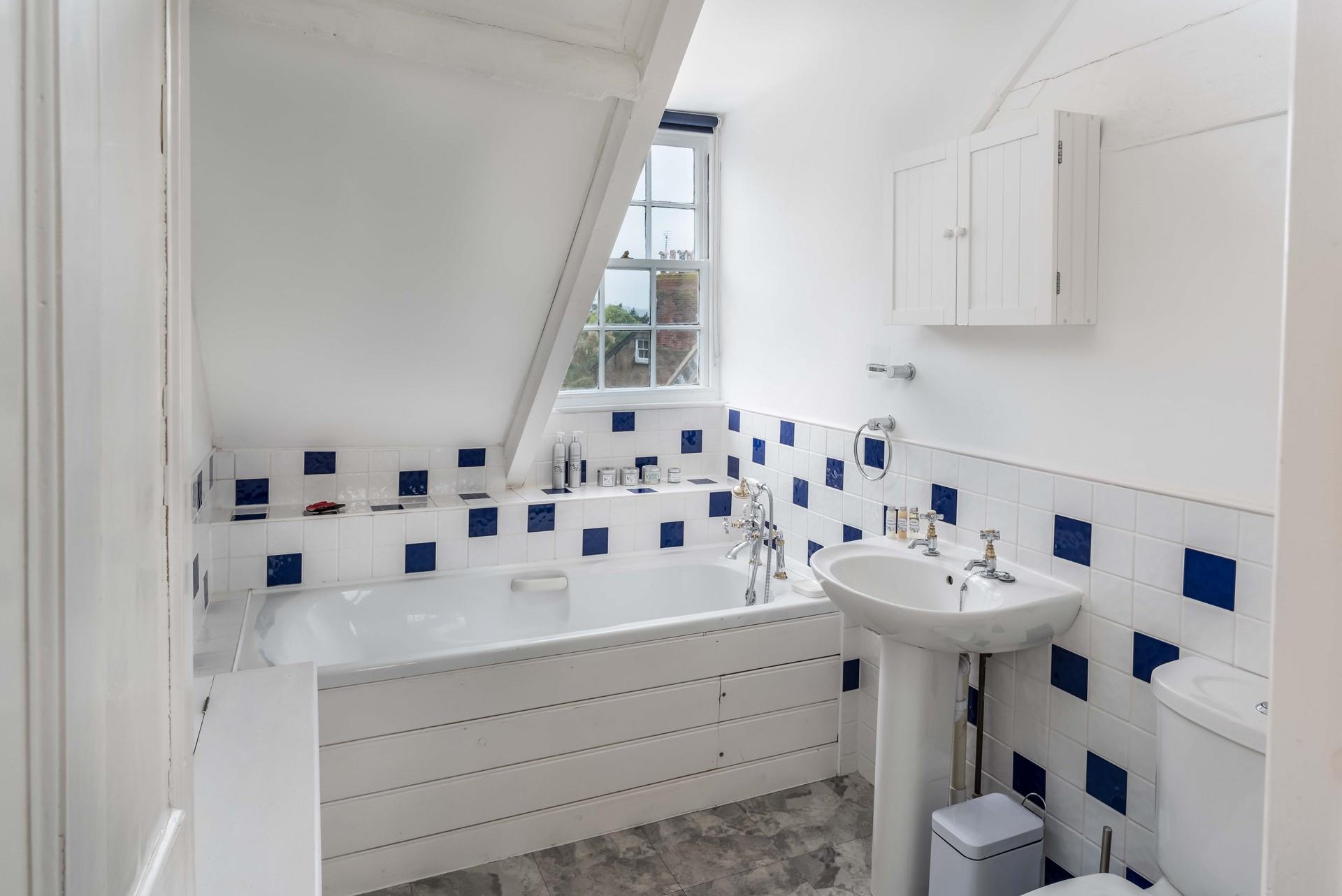 Second floor bathroom with restricted ceiling and church views.