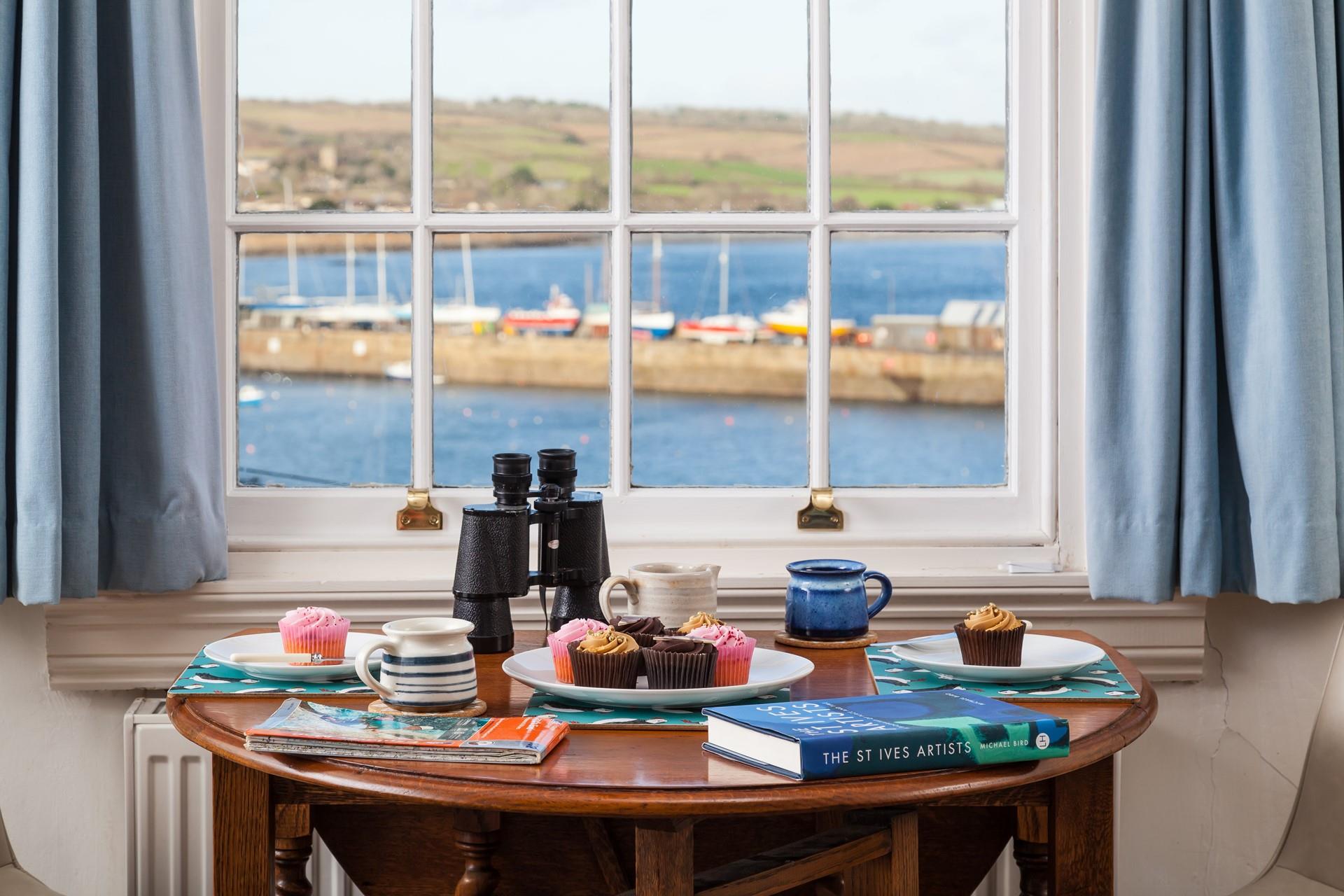 Enjoy a Cornish cream tea overlooking the bobbing boats in the harbour.