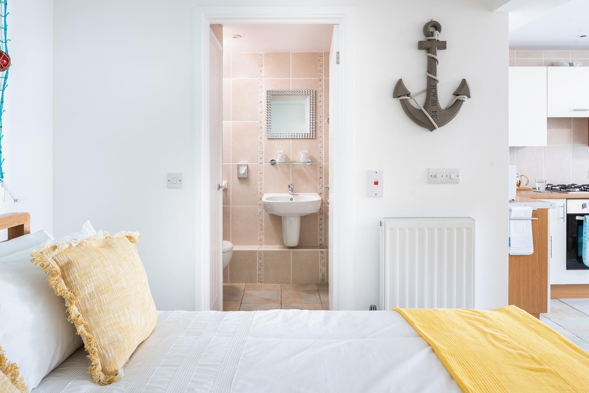 Crisp linen and soft sunshine hues make the bedroom area a blissful place to relax.