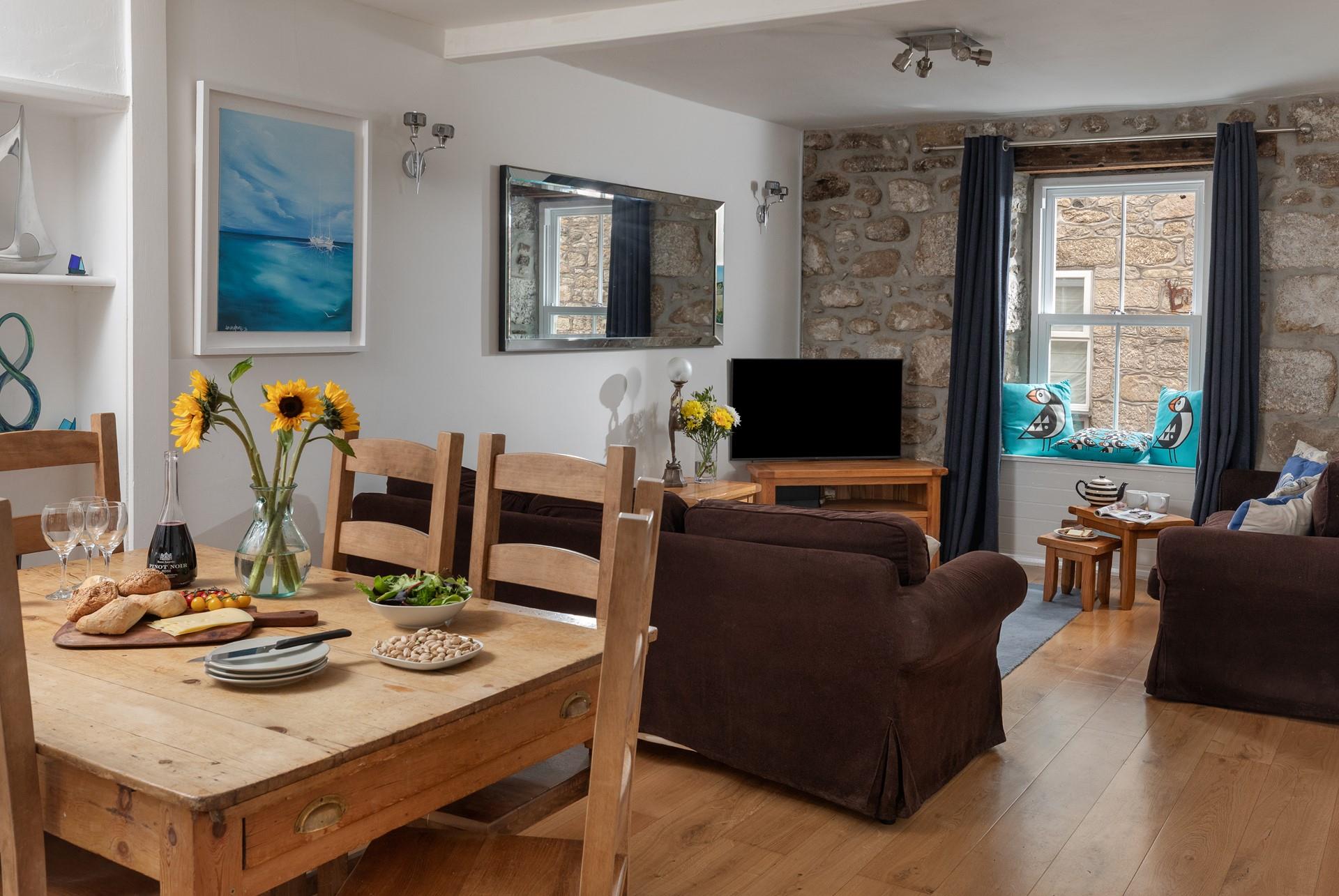 The sitting room has traditional features such as the lovely granite wall.
