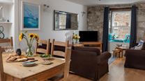 The sitting room has traditional features such as the lovely granite wall.