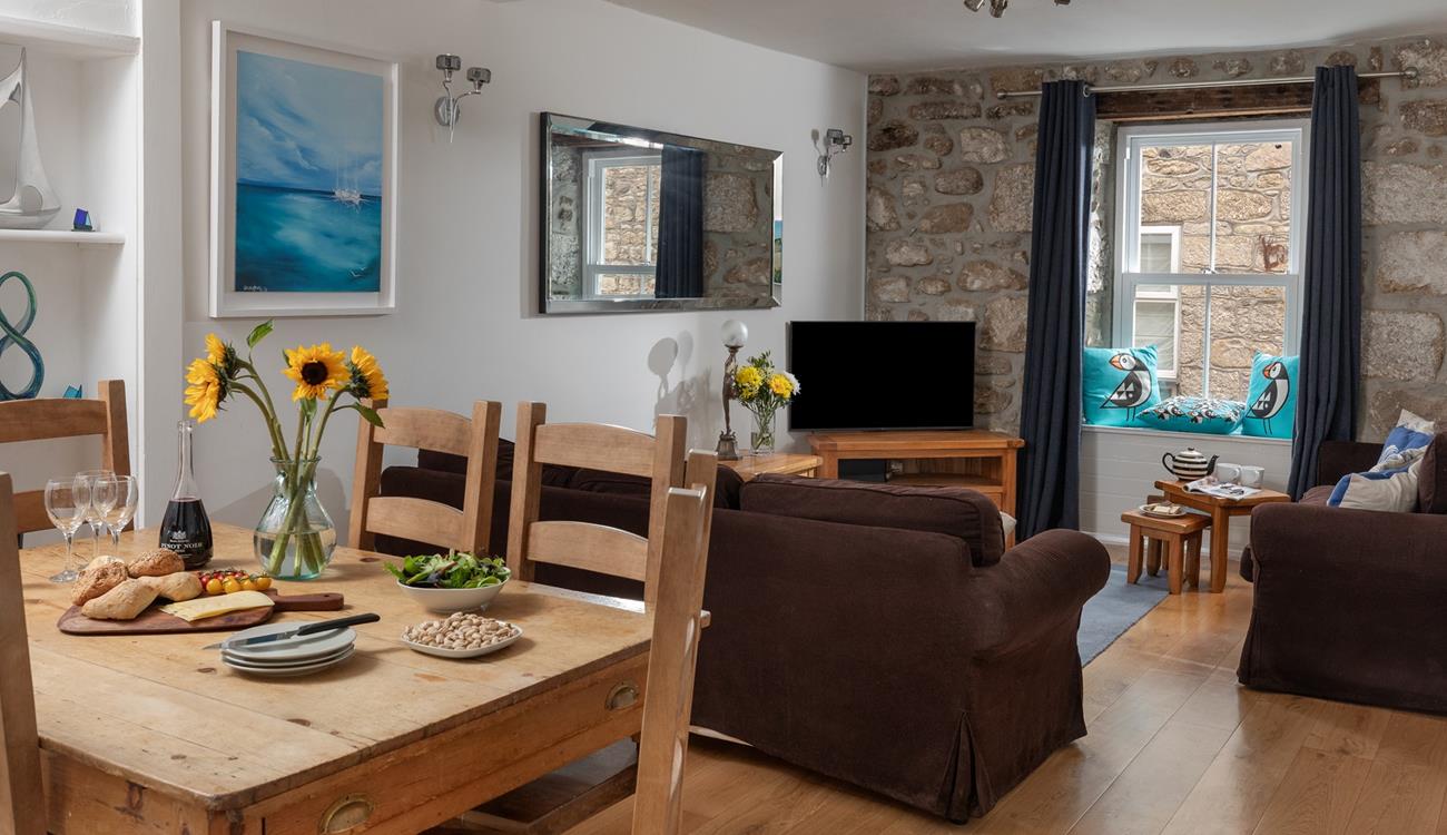 The sitting room has traditional features such as the lovely granite wall.