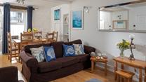 The cosy sitting room provides a relaxing retreat to return to.